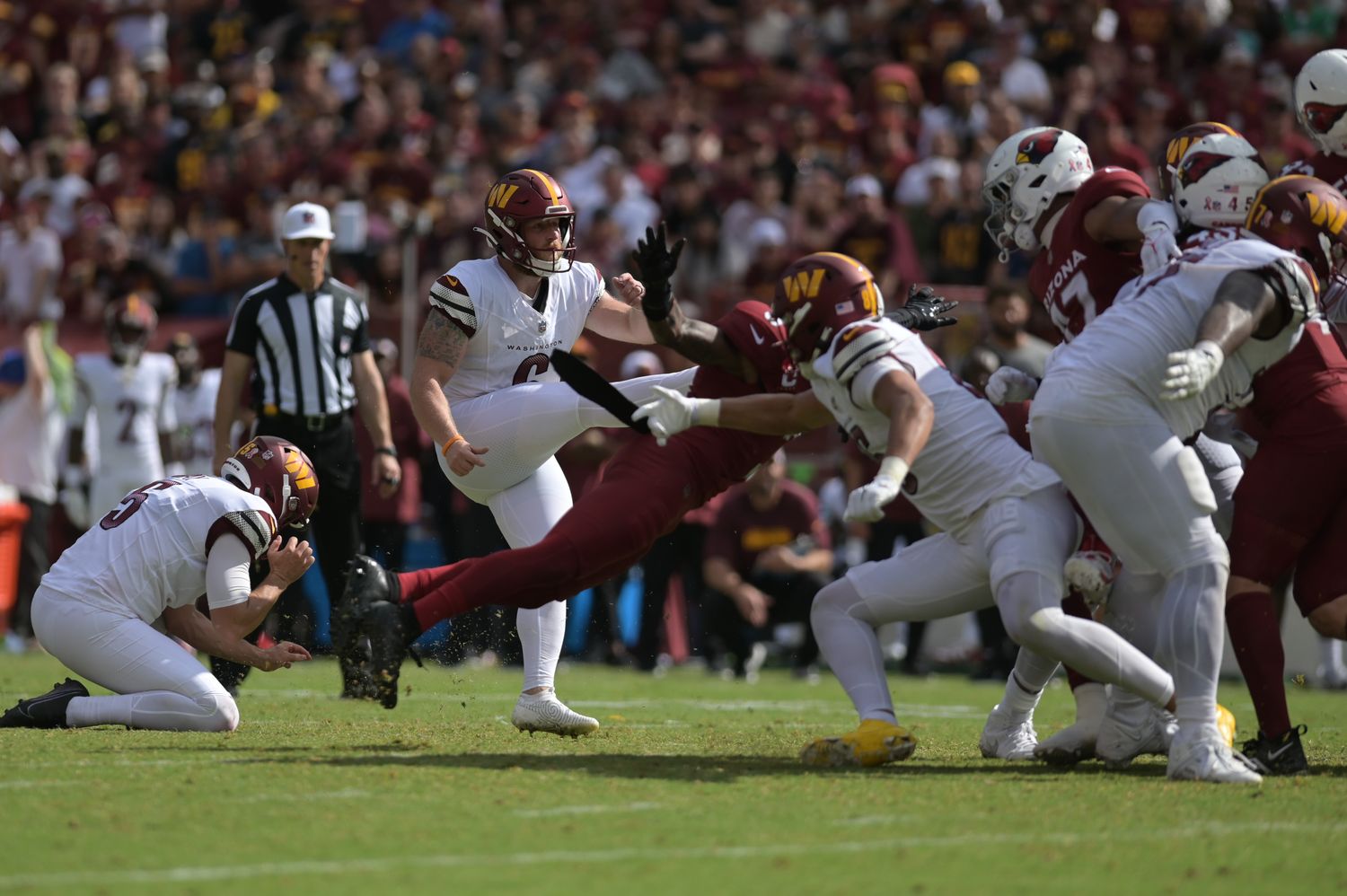 Washington Commanders place kicker Joey Slye (6) kicks the eventual game winning field goal against the Arizona Cardinals during the fourth quarter at FedExField.